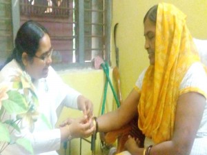 B.K. Preeti Tying Rakhi to Senior Scientific Officer Dr. Kiran Singh